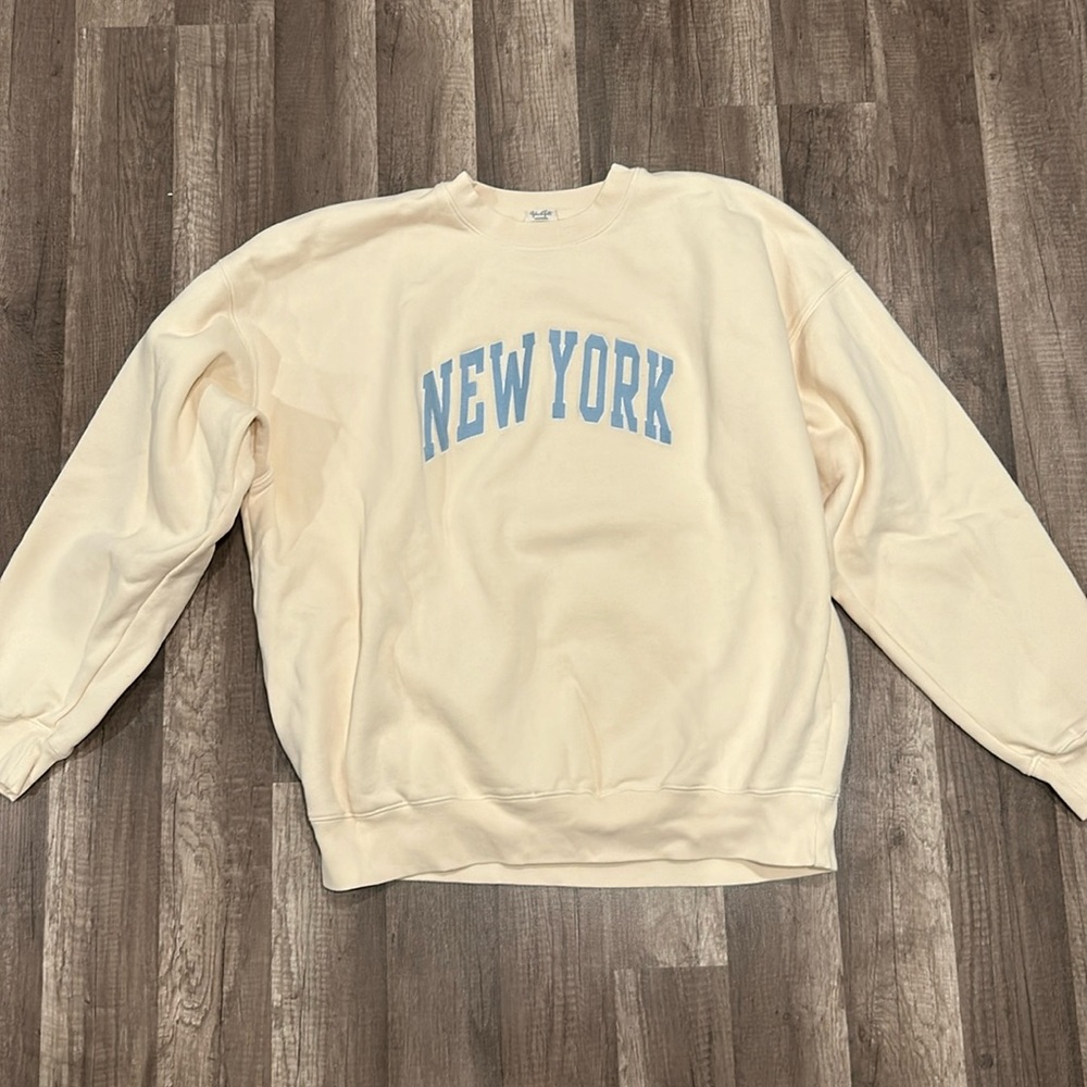 Brandy Melville Cream Sweatshirt with Light Blue "NEW YORK" Print